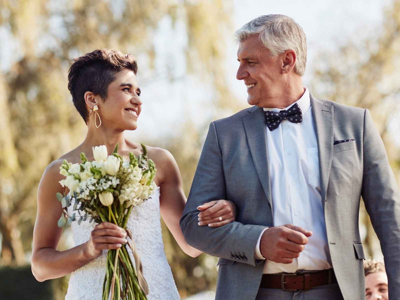 Father walking daughter down wedding aisle
